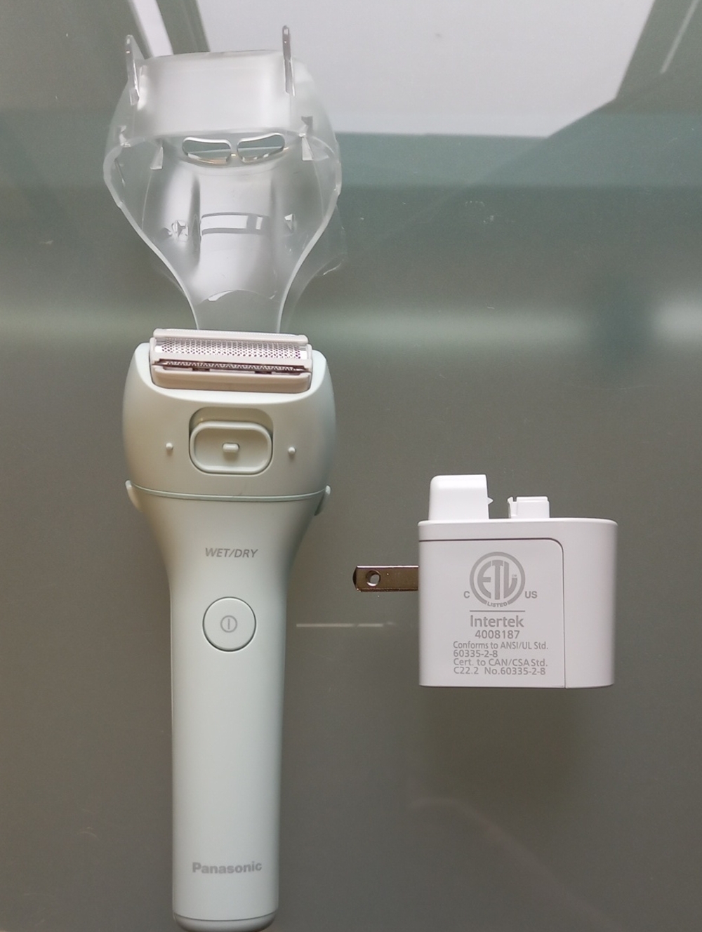 Compact Panasonic electric shaver in light mint.